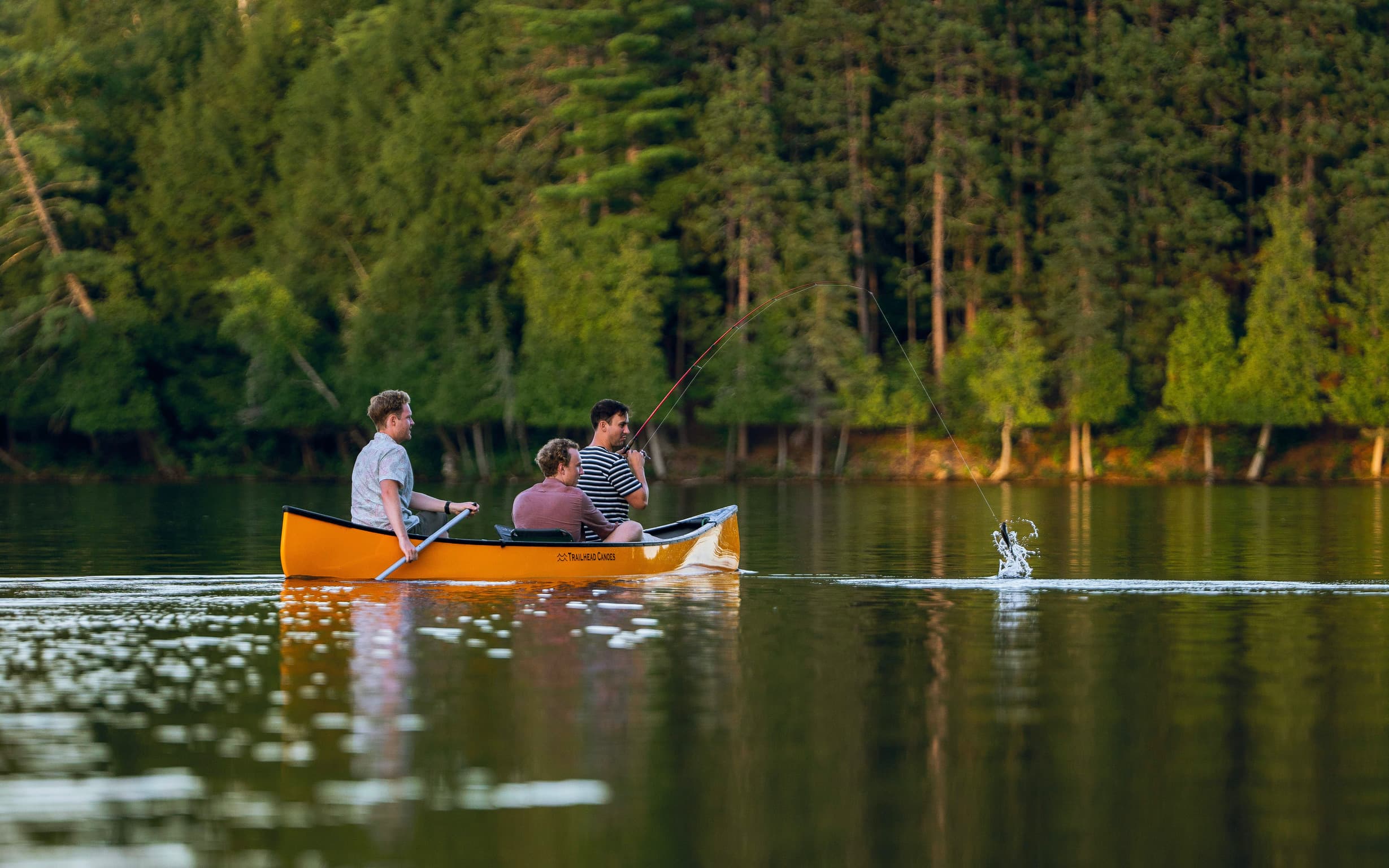 Man catches fish close to cottage Man catches fish close to cottage